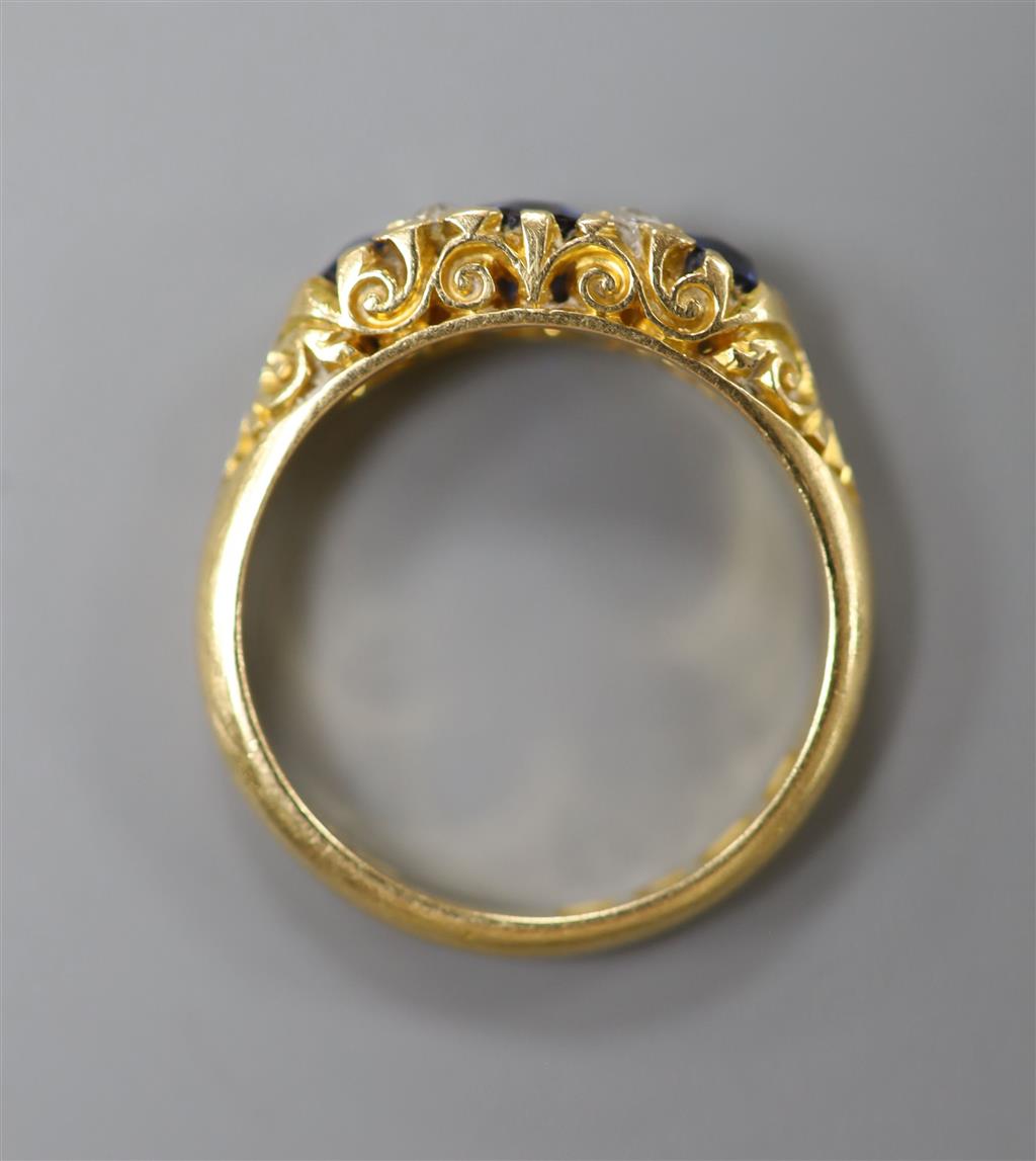A late Victorian 18ct gold, three stone sapphire and four stone diamond chip set half hoop ring, size L, gross 4 grams.